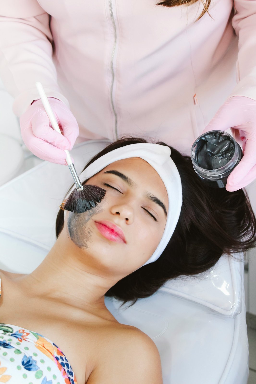 Patient receiving a facial mask treatment (sample photo)